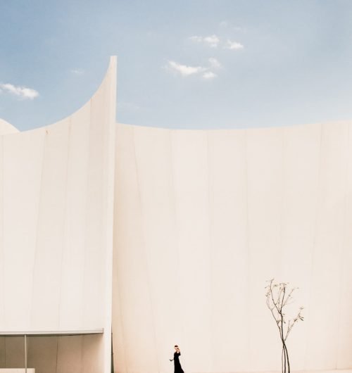Hoc Volo arquitectura Madrid woman standing in front of white building
